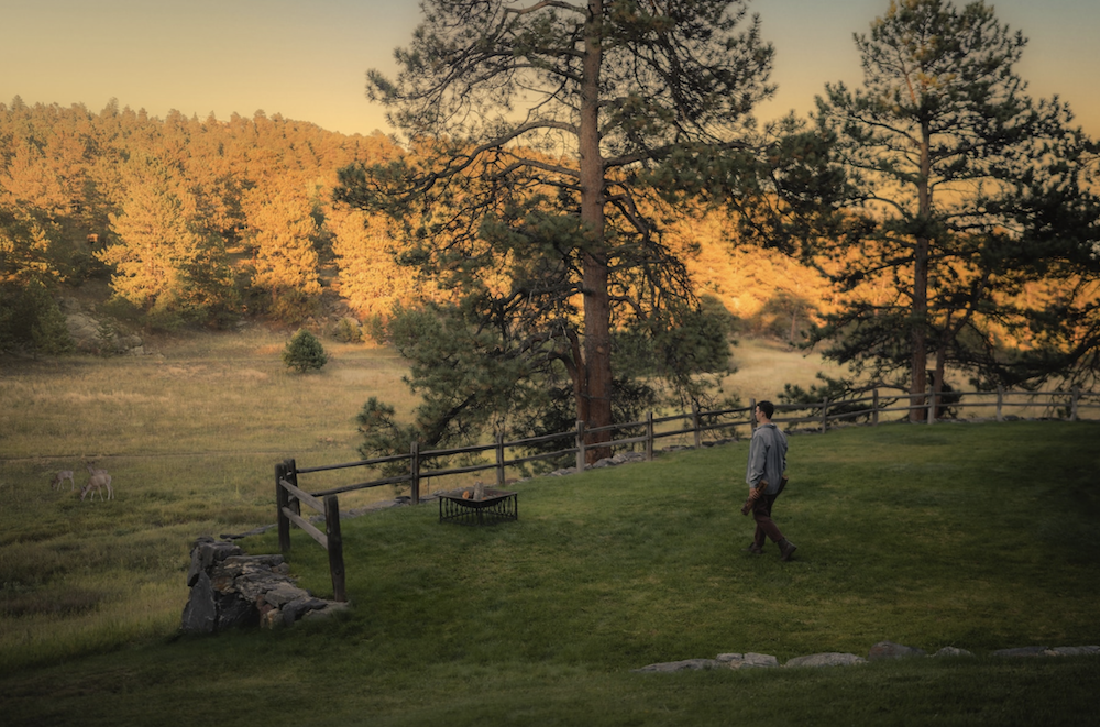 Man Carrying Log to Firepit